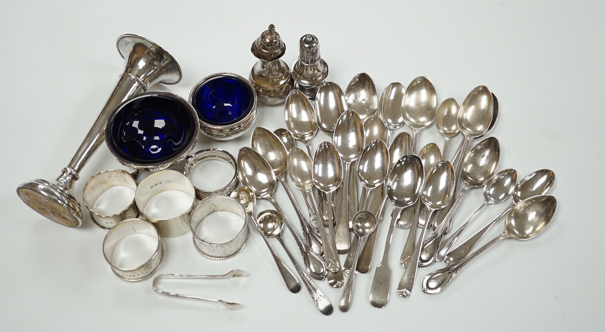 A small collection of assorted small silver including five napkin rings, a posy vase, two pepperettes, two small salts including Irish(marks very rubbed) and twenty eight small spoons.